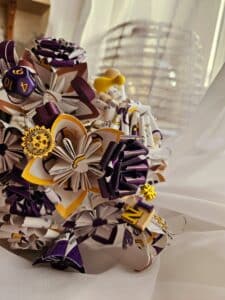 Gros plan sur un bouquet de mariée réalisée à partir des surplus des faire-part des mariés